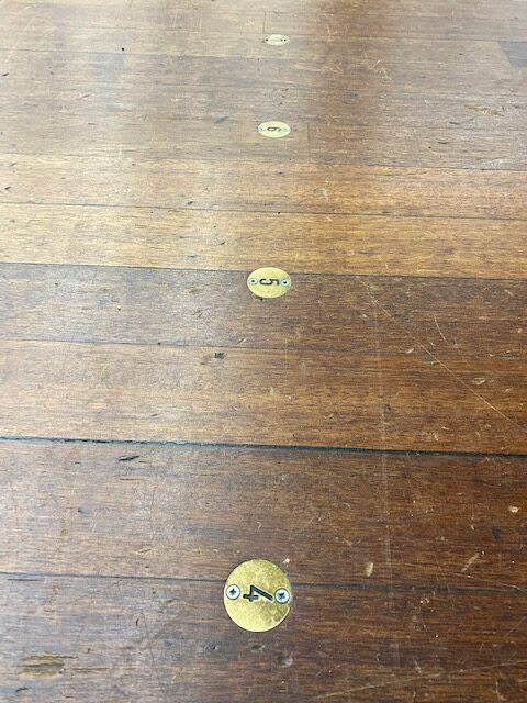 brass numbering and marking of stage floor